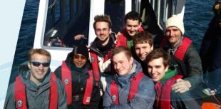 IDCore Research Engineers, wearing lifejackets on a boat, near Oban