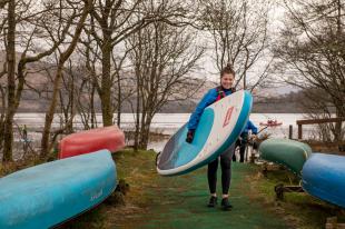 Katie Smith carrying SUP board