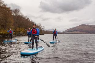 Nian Liu leading group of IDCORE students on SUP boards