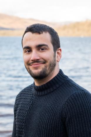 photo of Prokopis Vlachogiannis with sea and mountains in the background