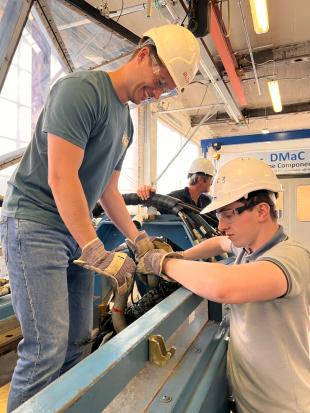 engineers working on Seiche Marine Acoustic Solutions waering hard hats and safety gear