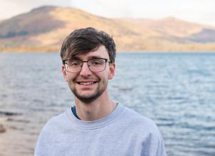 photo of Bryn Townley with loch and mountains in background