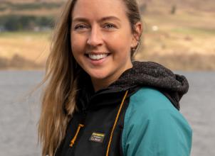 photo of Eve Andrews with loch and mountains in background