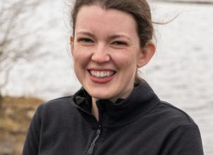 photo of Ione Smith with sea and mountains in background