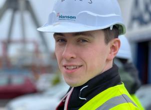 headshot of Simon McLaughlin weating hard hat and high viz vest, looking towards camera